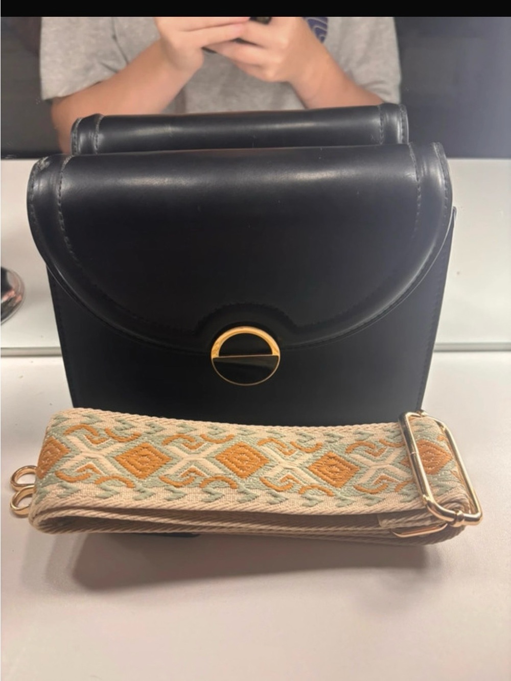 Black Leather Crossbody with Gold Accent and Decorative Woven Strap